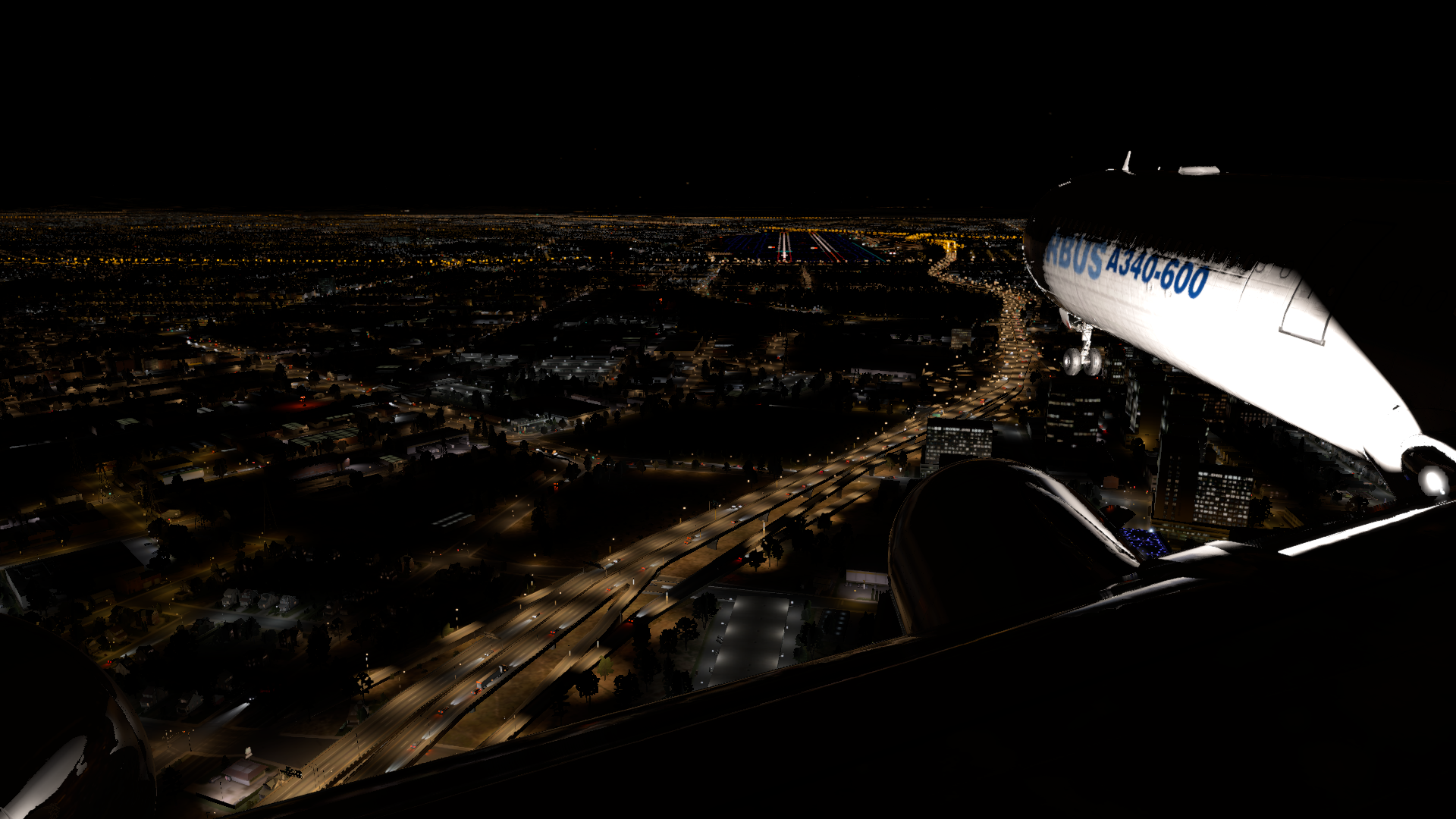 A340-600 on approach to KSJC 30L, just passing over downtown San Jose at night. The freeway is all lit up and the runways are visible. It's a dark night.