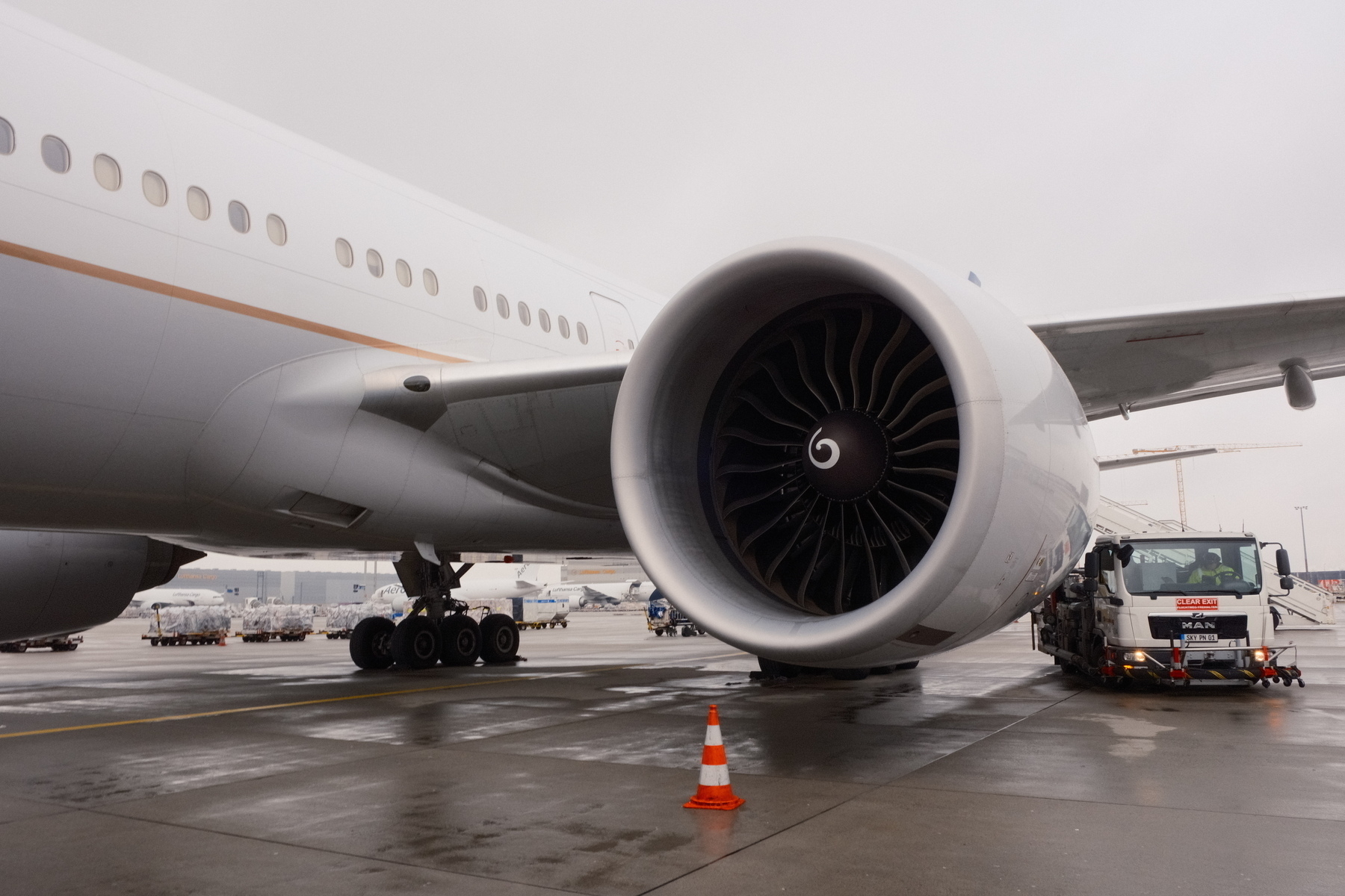 United 777-300 engine on a damp tarmac 