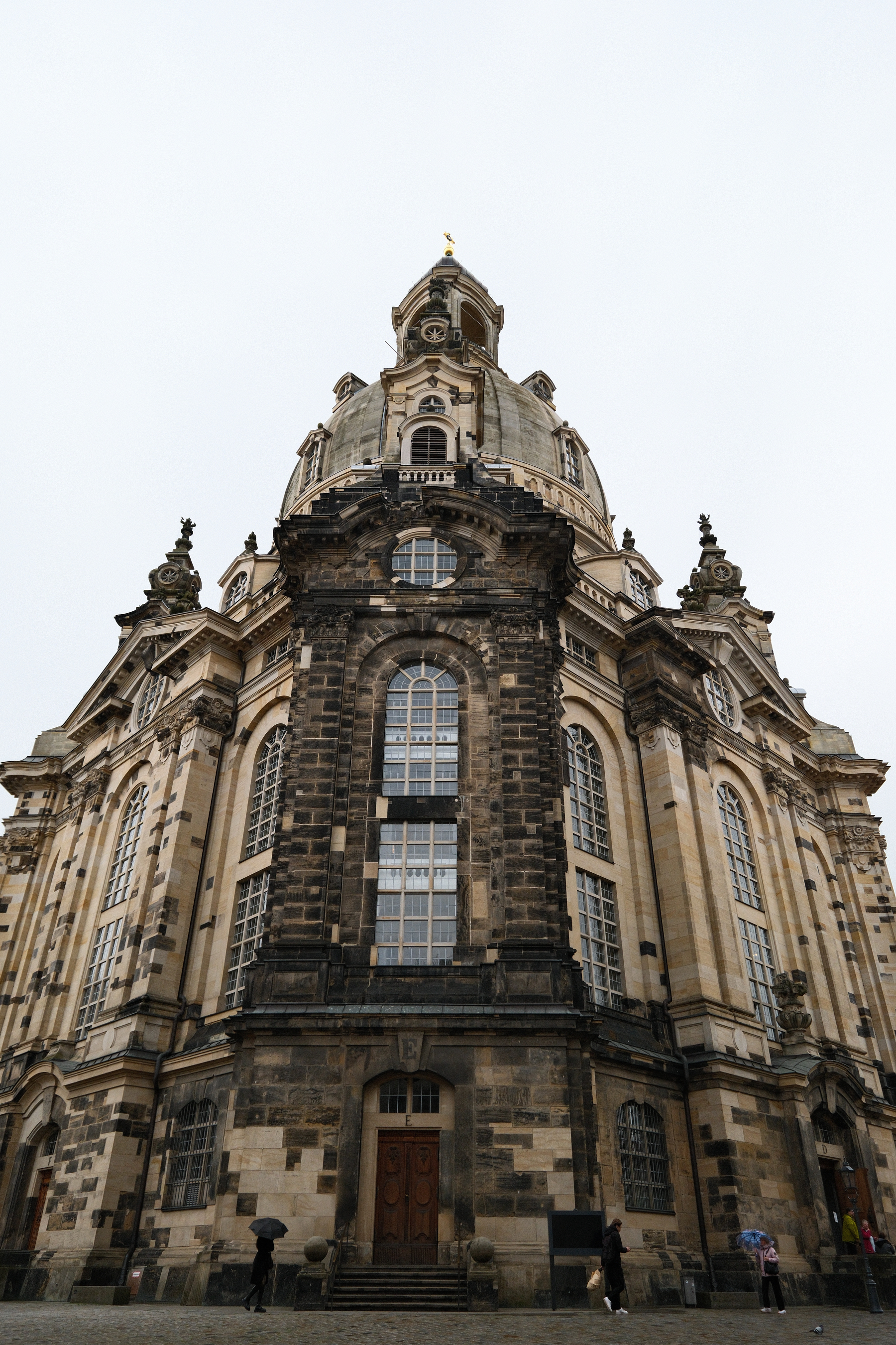 Auto-generated description: A majestic, historic church building with a large dome and intricate architectural details is viewed from a low angle.